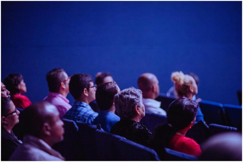 An attentive group of adults seated at an indoor c
