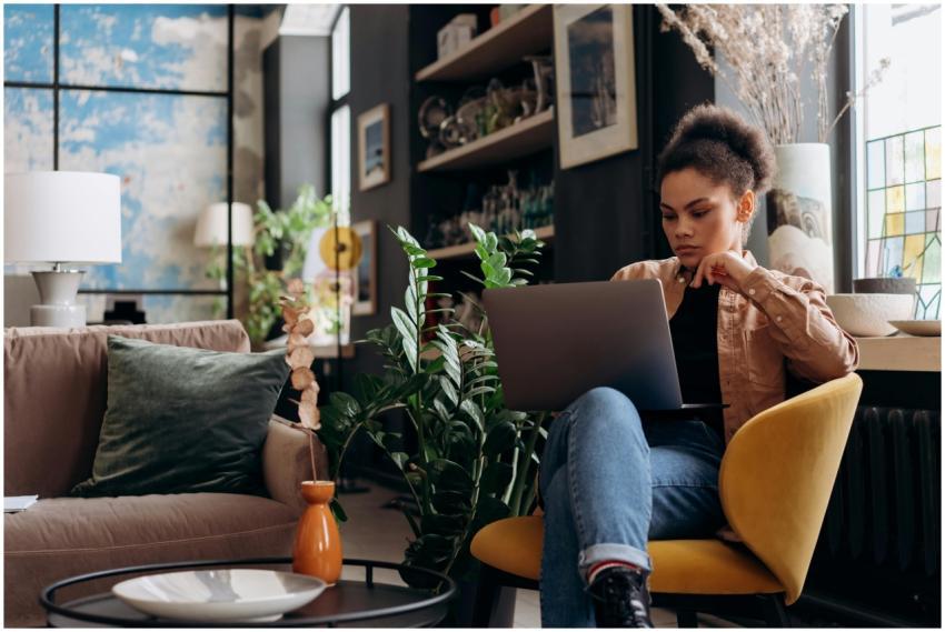 Focused woman working on laptop in a stylish home