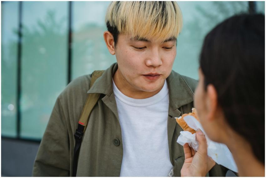 Cheerful young couple enjoying a delicious street