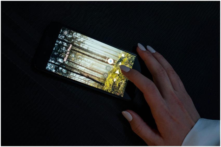 A hand interacting with a smartphone displaying a