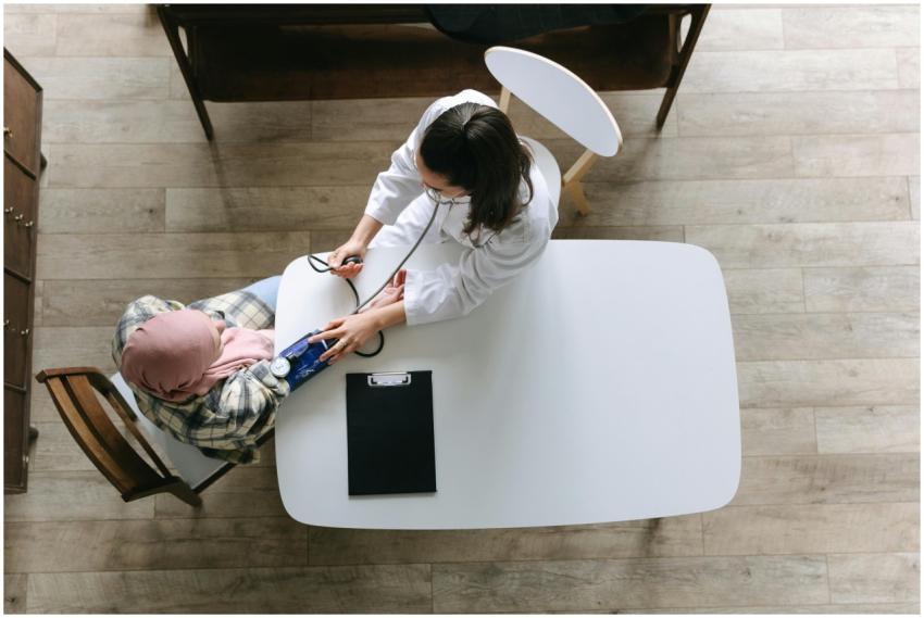 Overhead view of a doctor checking a patient's blo