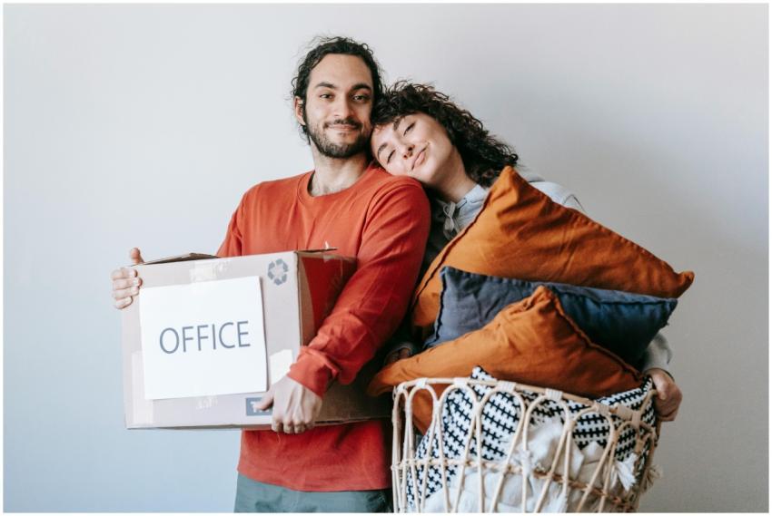 A happy couple packing up their home office, showc