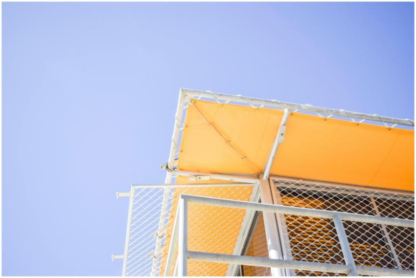 A bright low angle shot of a yellow metal structur