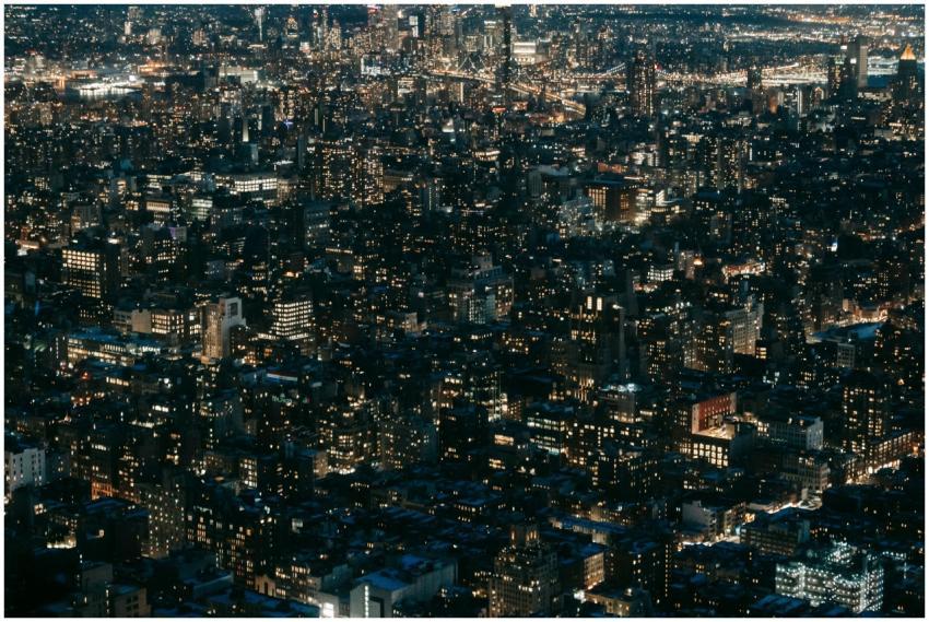 Drone view of modern multistory buildings with glo