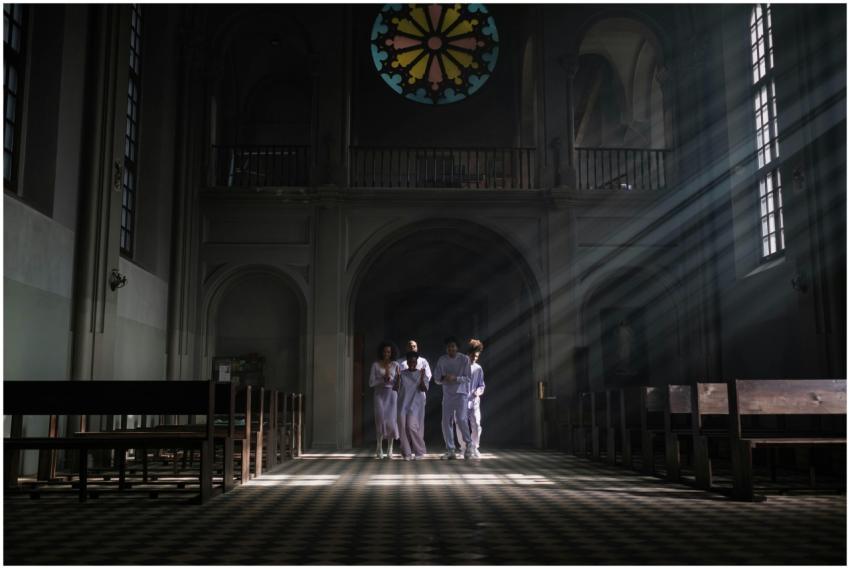 Choristers in uniforms sing under sunrays in a cat