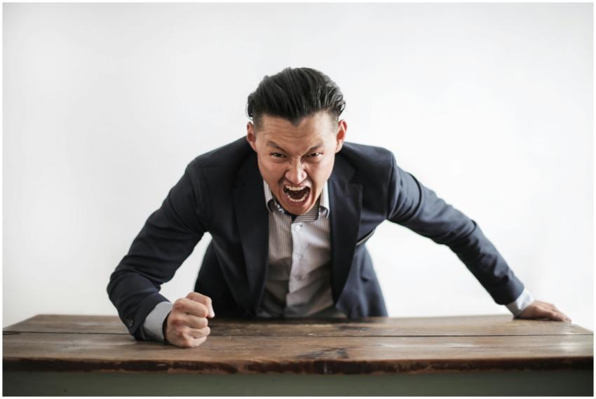 Expressive angry businessman in formal suit lookin
