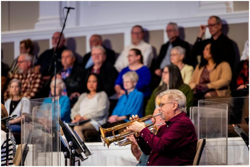 A trumpet player performs at an indoor concert sur
