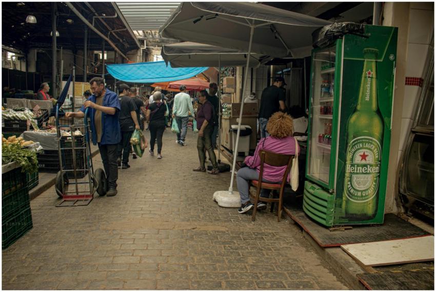 Busy indoor market scene with people shopping and