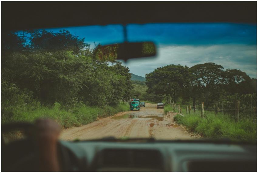 Experience a scenic drive on a rural dirt road, su