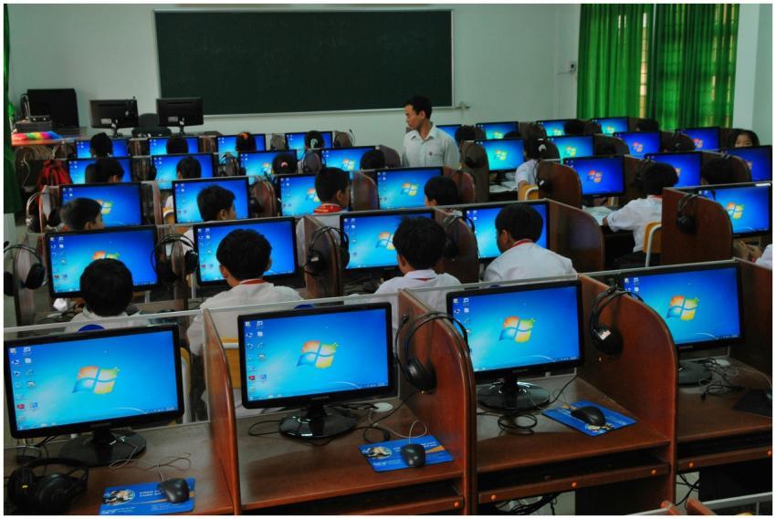 Students learning in a computer lab with multiple