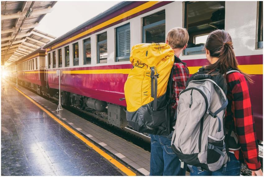 Backpackers waiting at a train station platform, r