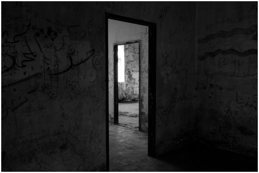 Dark, abandoned building interior with eerie shado