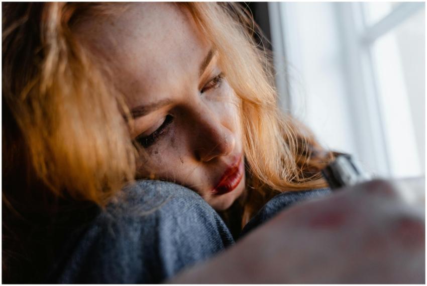 Close-up of a woman with red hair in a thoughtful