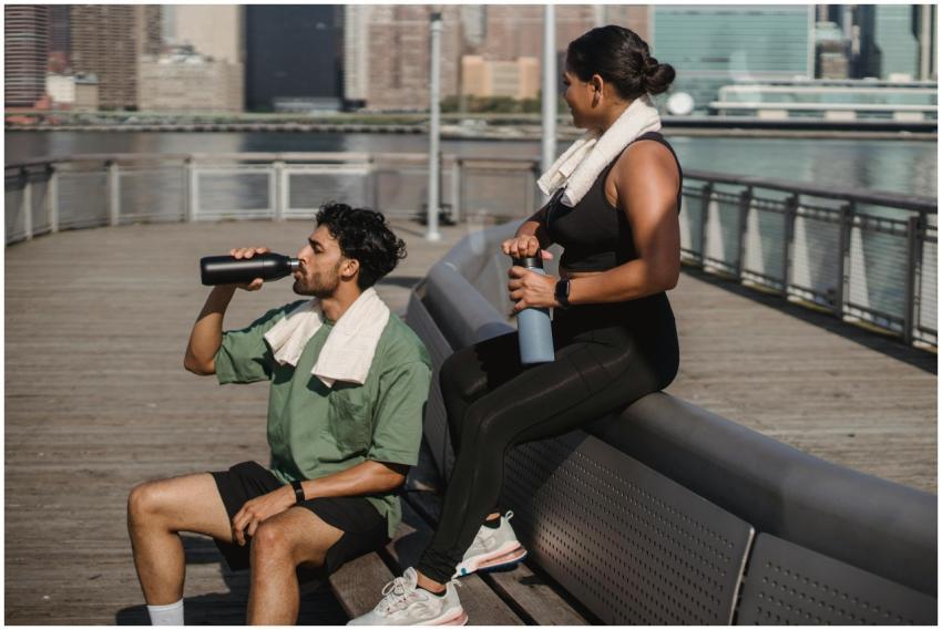 Man and woman resting after exercise by a riversid
