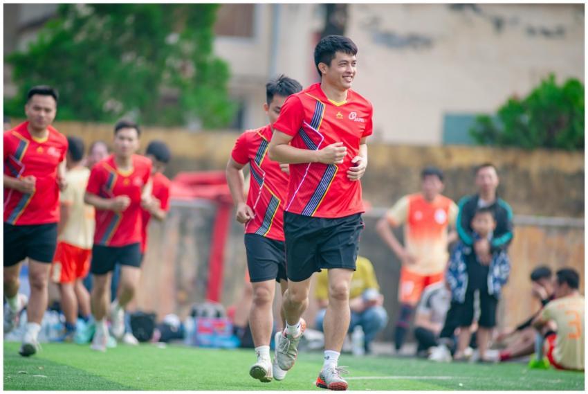 Group of athletes jogging outdoors on a field in H