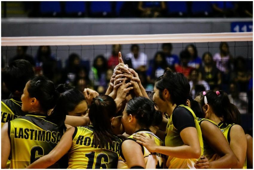 Female volleyball team huddles for a game in Quezo