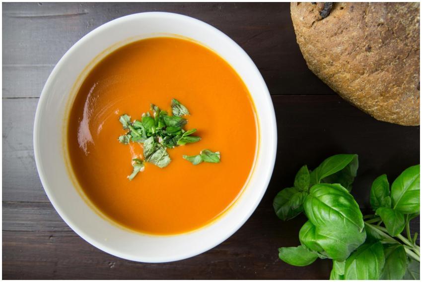 Delicious homemade tomato soup served with basil l