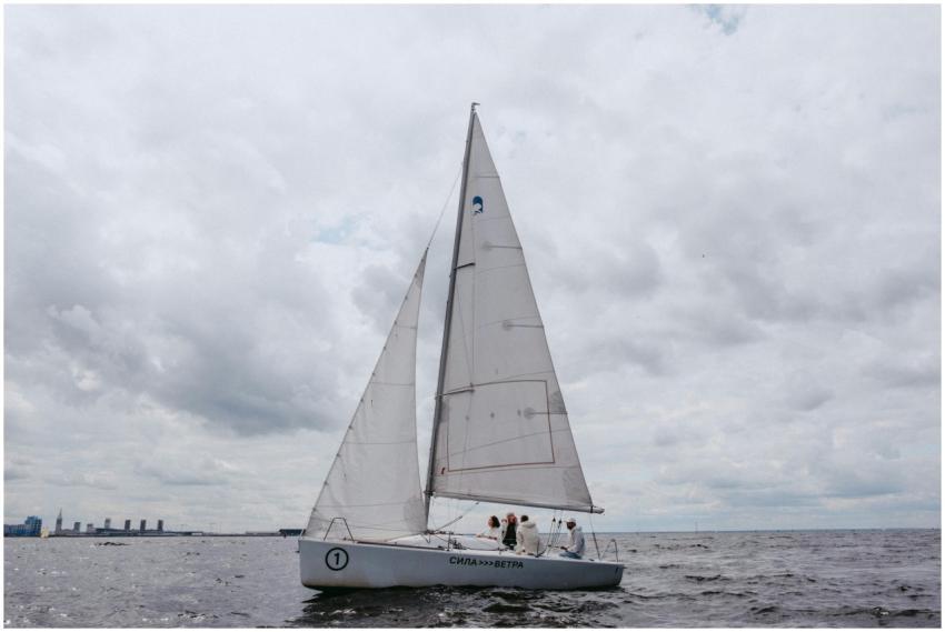 A yacht sailing on the ocean with a team onboard u