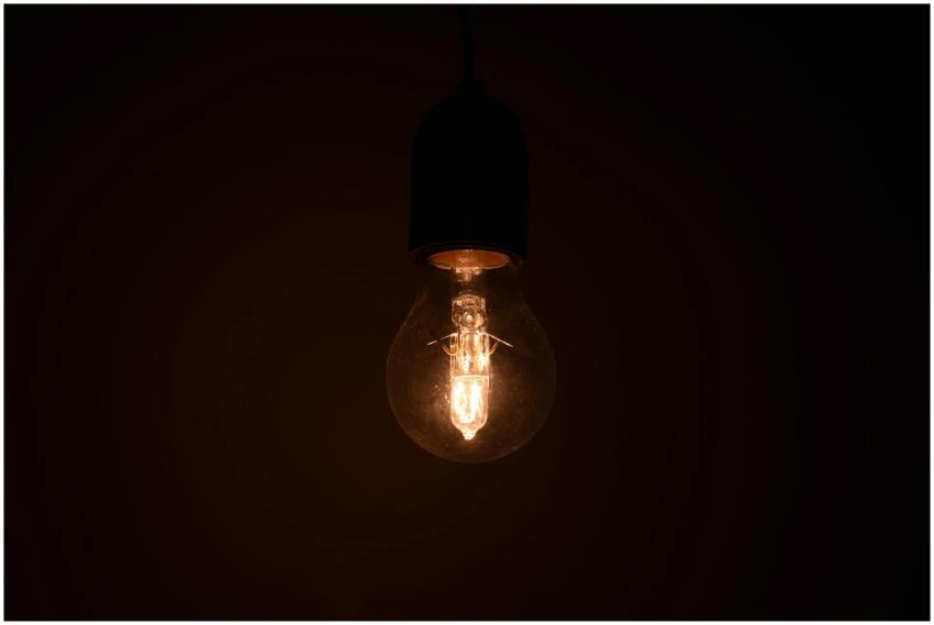 Close-up view of an illuminated light bulb glowing