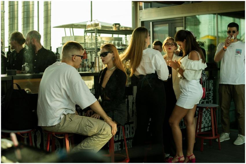 Stylish group of adults socializing at a rooftop b