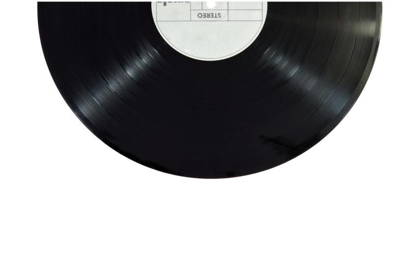 A classic black vinyl record isolated on a white b