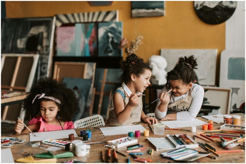 Three young girls enjoying a creative painting ses