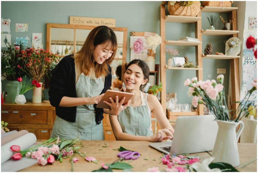 Content multiethnic female florists in aprons at t