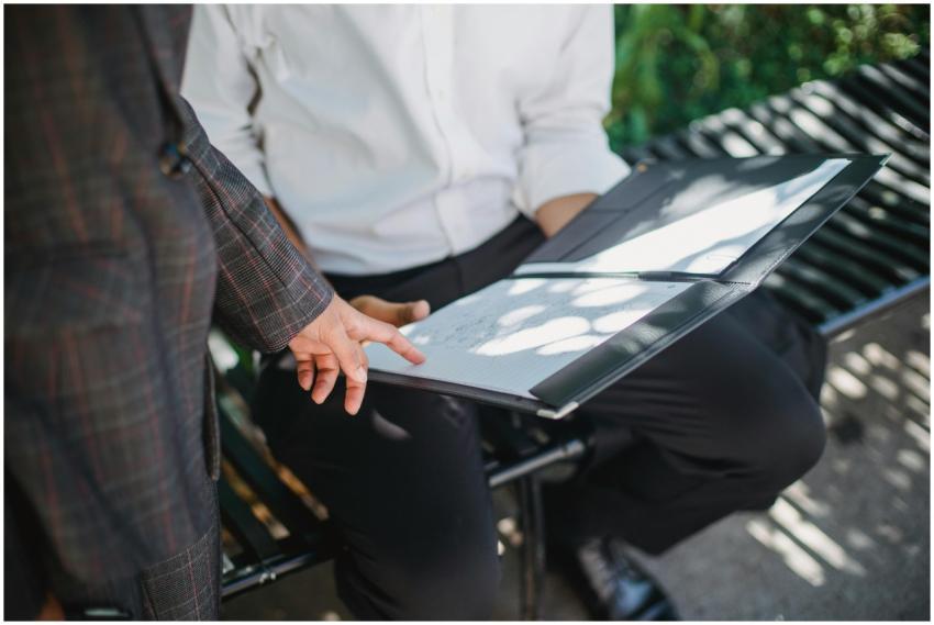 Two professionals in an outdoor setting reviewing