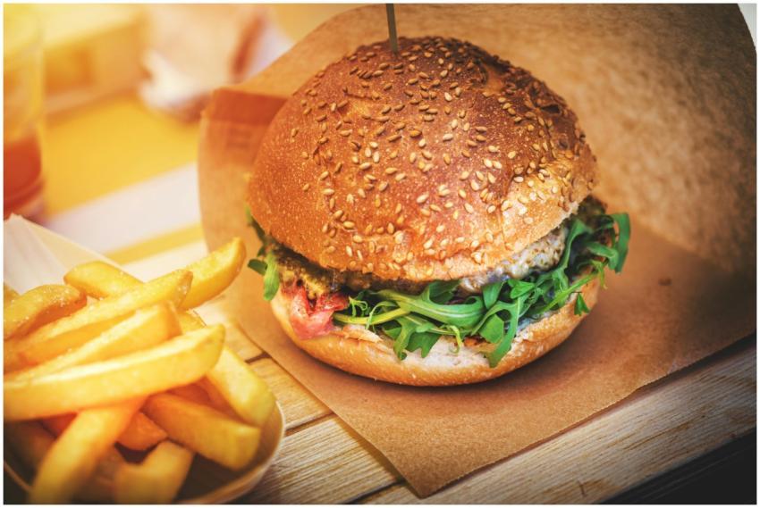 Close-up of a sesame seed bun burger with fresh ar