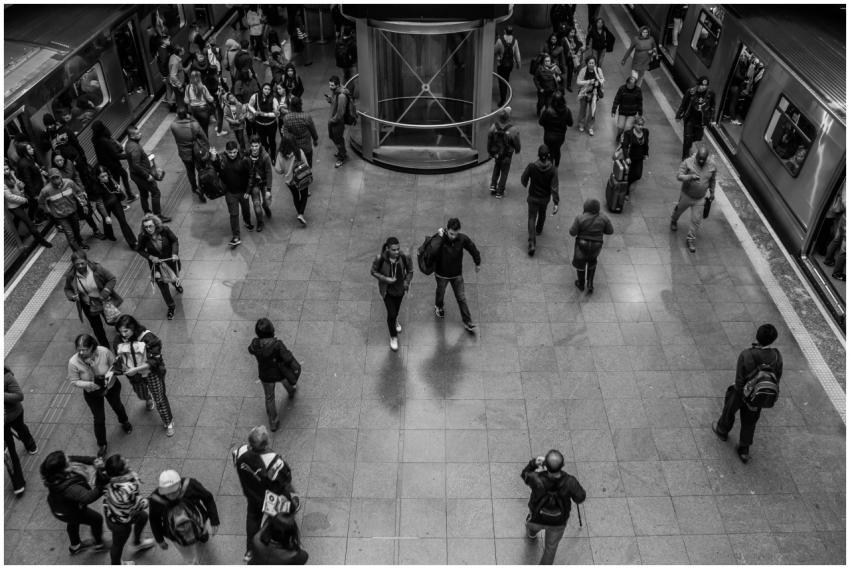 Black and white image of commuters in a bustling s