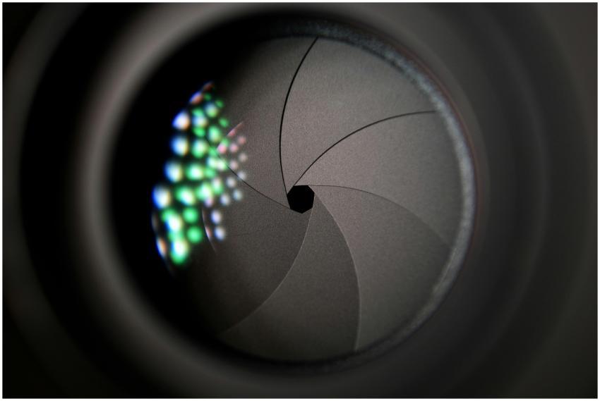 Detailed image of a camera lens aperture showing m