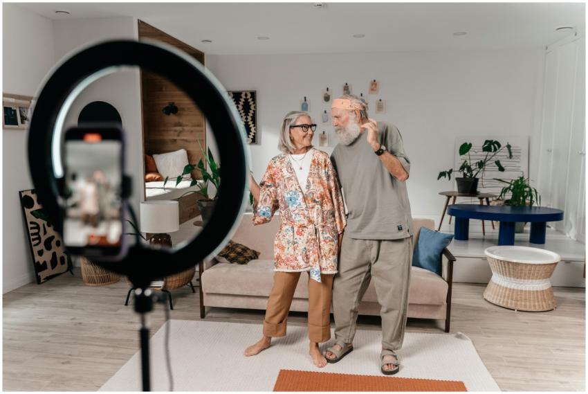 A joyful senior couple dances at home while record