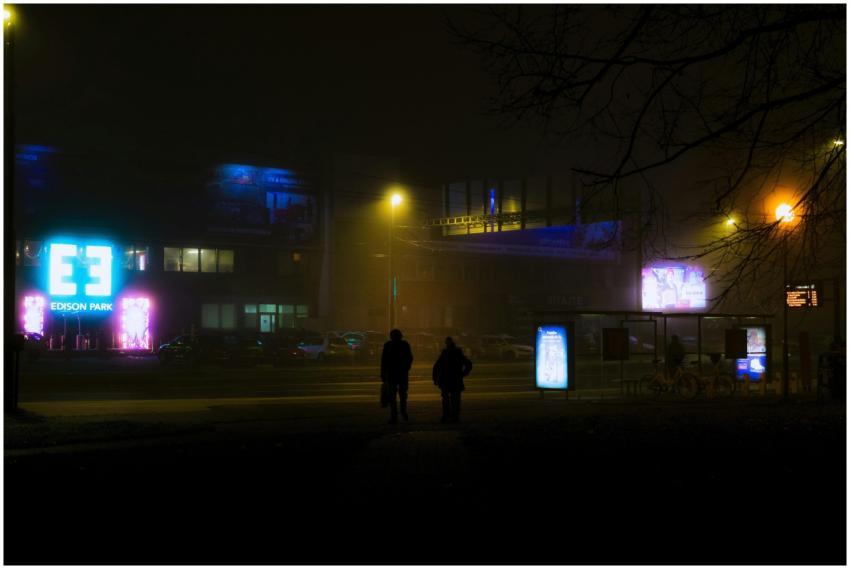 A foggy night street scene in Bratislava featuring