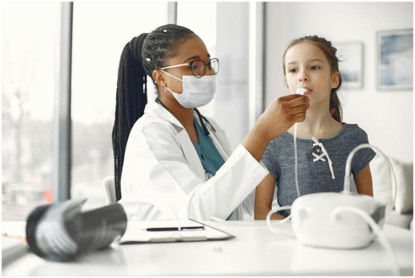 A healthcare professional examines a young girl wi