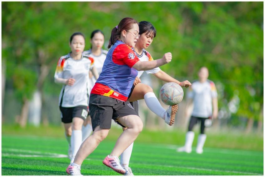 Women players compete fiercely in a soccer match i