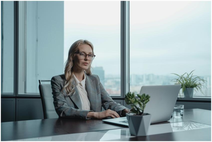 A confident businesswoman in a grey suit working o