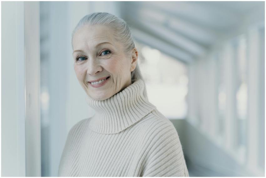 Elegant senior woman with grey hair smiling in a s