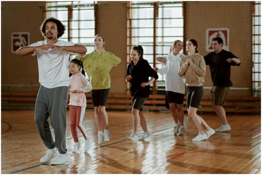 A diverse group engages in an energetic indoor fit