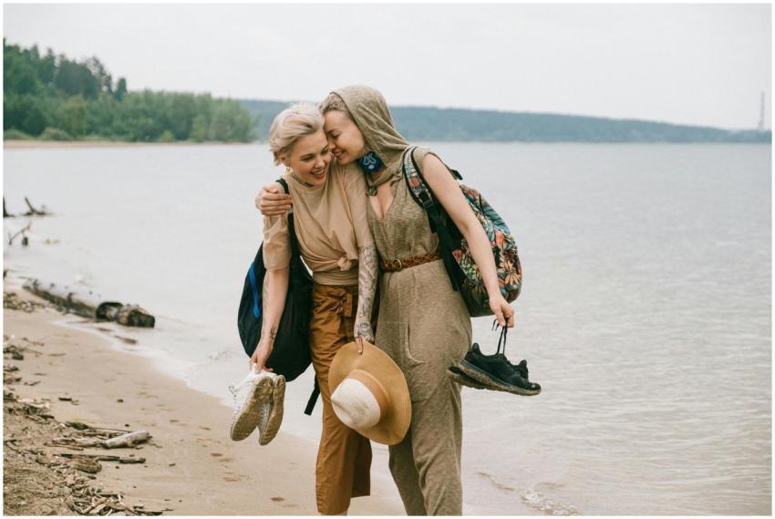 Two friends enjoy a joyful walk along the beach, e