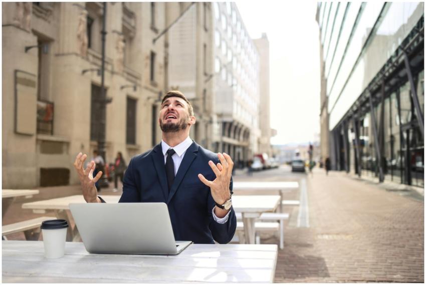 Businessman in suit showing frustration at outdoor