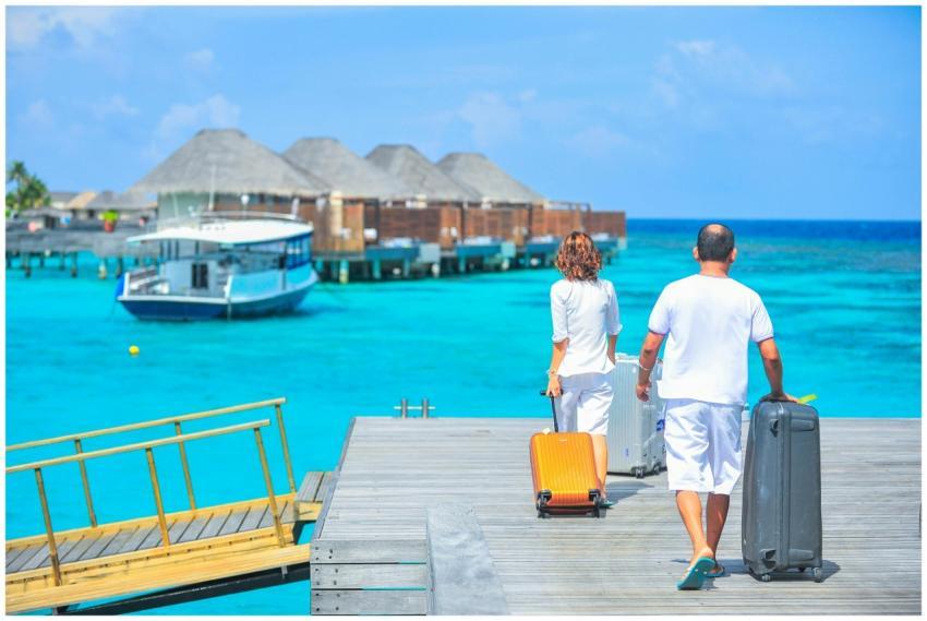 A couple arriving at a luxurious Maldives resort d