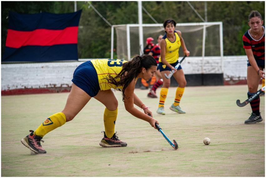 Dynamic action shot of female field hockey players
