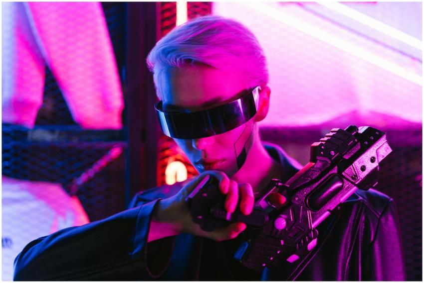 A stylish woman in cyberpunk attire poses with a f