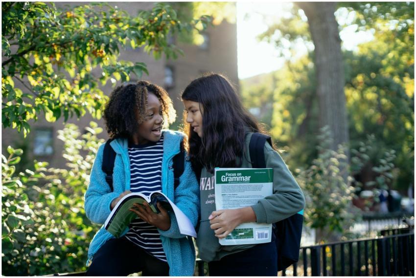 Cheerful multiracial friends in casual clothes wit
