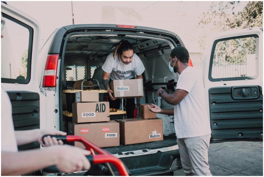 Volunteers unloading boxes labeled food and medici