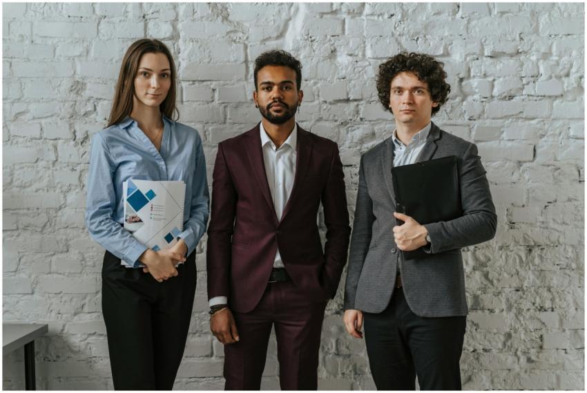 Three business professionals standing confidently