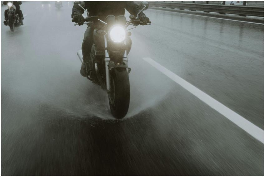Motorcyclists navigate a wet highway at night, spl