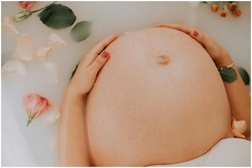 Pregnant woman relaxing in a soothing milk bath wi