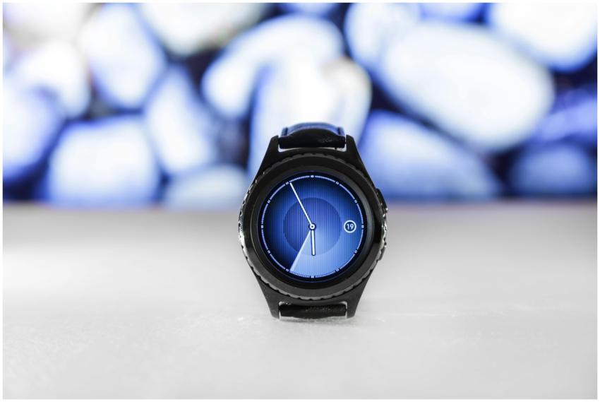 A sleek digital smartwatch with a blue interface a