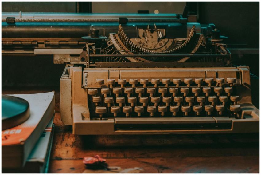 Close-up of a vintage typewriter on a wooden desk